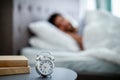 Early awakening concept. Man sleeping through alarm clock in the morning, lying in bed