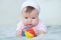 Early brain development. concentrated little baby girl playing with rattle