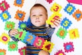 Early childhood education, preschool and kids game concept. Happy baby boy learning to count. Royalty Free Stock Photo