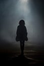 mysterious african american teen girl walking down a dark road. Royalty Free Stock Photo