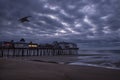 Early dawn morning on the ocean. An old wooden pier with houses Royalty Free Stock Photo