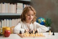 Early development. Boy thinking about chess. The concept of learning and growing children. Chess, success and winning. Royalty Free Stock Photo