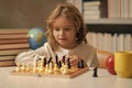 Early development. Boy thinking about chess. The concept of learning and growing children. Chess, success and winning Royalty Free Stock Photo