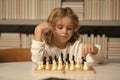 Early development. Boy thinking about chess. The concept of learning and growing children. Chess, success and winning. Royalty Free Stock Photo