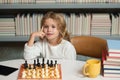 Early development. Child thinking about chess. The concept of learning and growing children. Chess, success and winning Royalty Free Stock Photo