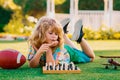 Early development. Boy thinking about chess in summer park. The concept of learning and growing children. Chess, success Royalty Free Stock Photo