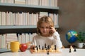 Early development. Child thinking about chess. The concept of learning and growing children. Chess, success and winning. Royalty Free Stock Photo