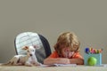 Early development for children. Education childhood and school concept - cute little student with pet puppy dog writing Royalty Free Stock Photo