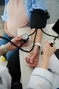 Hypertension, pre-eclampsia and eclampsia in pregnancy. Close-up doctor measuring blood pressure of pregnant woman. Royalty Free Stock Photo