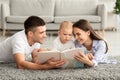 Early Education For Kids. Parents Reading Book To Their Cute Toddler Son Royalty Free Stock Photo