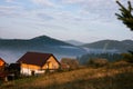 Early foggy morning in the mountains. Carpathians, Bukovel, lawn houses.