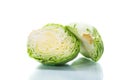 Early green cabbage cut in half swing on a white background Royalty Free Stock Photo