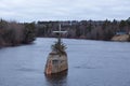 Early grey spring morning view of a large metal catholic cross on former Gouin bridge pillar in the Jacques-Cartier River Royalty Free Stock Photo