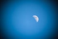 Early half moon in blue sky background Royalty Free Stock Photo