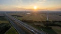 Sunrise Over Farmland, Windmills, and Highway Royalty Free Stock Photo