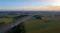 Sunrise Over Farmland, Windmills, and Highway Royalty Free Stock Photo