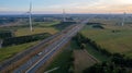 Sunrise Over Farmland, Windmills, and Highway Royalty Free Stock Photo