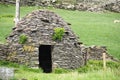 Early medieval stone-built round house clochain beehive hut on Dingle Peninsula, Kerry, Ireland. A Clochain is a dry-stone hut Royalty Free Stock Photo