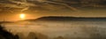 Early morning autumnal mist over East Meon village with Butser Hill and the South Downs in the background, South Downs National