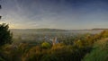 Early morning autumnal mist over East Meon village with Butser Hill and the South Downs in the background, South Downs National