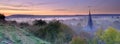 Early morning autumnal mist over East Meon village with Butser Hill and the South Downs in the background, South Downs National