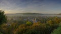 Early morning autumnal mist over East Meon village with Butser Hill and the South Downs in the background, South Downs National