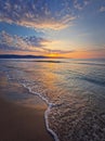 Early morning on the beach with a peaceful view to the sunrise above the sea. Calm seascape dawn scene, natural background. Summer Royalty Free Stock Photo