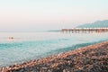 Early morning beach pier and sea against clear skyline Royalty Free Stock Photo