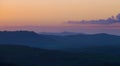 Early morning beautiful Tuscany hills  landscape view with plowed and green grass covered wavy fields. Sunrise light covering the Royalty Free Stock Photo