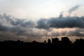 Early morning cloudscape with silhouette of building