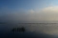 Early morning dawn near the river over the water, swirling mist, the water reflected Royalty Free Stock Photo