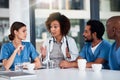 Early morning discussions with the doctors. a group of focused young doctors having a discussion together while being Royalty Free Stock Photo