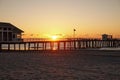 Early morning dramatic sunrise over the ocean and long pier Royalty Free Stock Photo