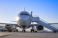 Early morning flight. Front view of an airplane boarding at a terminal gate