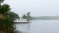 Early morning fog on Lake Irving with pontoon boat