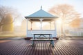 early morning frost on gazebo with empty benches