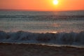 Early morning, the image of the sea at the sunrise. Waves, red s
