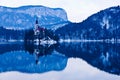 Early morning on the lake Bled and reflection of a church on small island Royalty Free Stock Photo
