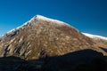 Early morning light and shadow over mountains and snow. Carnedd Llewelyn. Landscape, dark shadow foreground Royalty Free Stock Photo