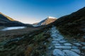 Early morning light and shadow over mountains and snow, stone path in foreground. Carnedd Llewelyn. Landscape Royalty Free Stock Photo