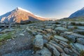 Early morning light and shadow over mountains and snow. Stone path in foreground and mountain  Carnedd Llewelyn. Landscape Royalty Free Stock Photo