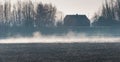 Early morning mist above a plowed field Royalty Free Stock Photo