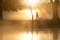 Early morning mist and fog over lake with passers by Royalty Free Stock Photo