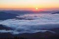 The early morning mist. Majestic spring day. A beautiful landscape with high mountains, sunset and sky with clouds. Dense fog with Royalty Free Stock Photo