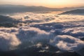 The early morning mist. Majestic spring day. A beautiful landscape with high mountains, sunset and sky with clouds. Dense fog with Royalty Free Stock Photo