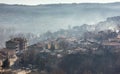 Early morning mist rolling down from the hills on to the rural landscape of Veliko Tarnovo, in Bulgaria. Autumn dawn with an orang Royalty Free Stock Photo