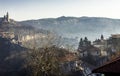 Early morning mist rolling down from the hills on to the rural landscape of Veliko Tarnovo, in Bulgaria. Autumn dawn with an orang Royalty Free Stock Photo