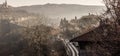 Early morning mist rolling down from the hills on to the rural landscape of Veliko Tarnovo, in Bulgaria. Autumn dawn with an orang Royalty Free Stock Photo