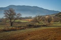 Early morning in the mountains, field and fog Royalty Free Stock Photo