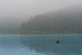 Misty mountain lake after sunrise